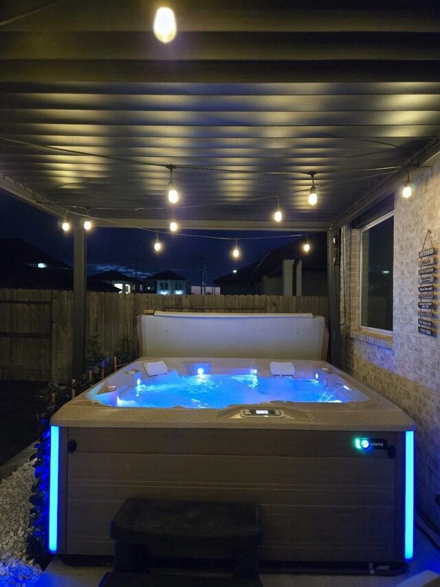 21811 Gibson Desert Dr, Cypress, TX 77433 - pool at night featuring a hot tub and fence