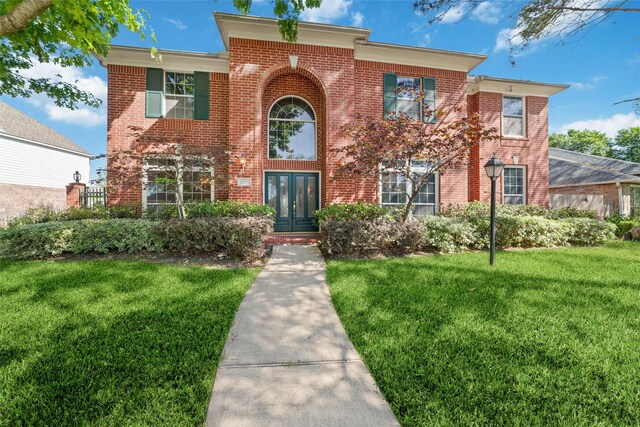 12236 S Shadow Cove Dr, Houston, TX 77082 - view of front of property with a front lawn, brick siding, and french doors