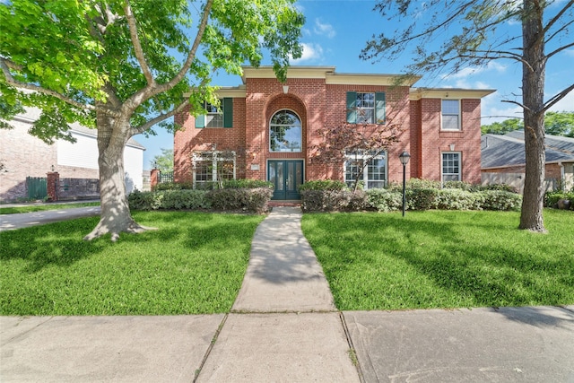 12236 S Shadow Cove Dr, Houston, TX 77082 - view of front facade with a front yard, brick siding, and french doors