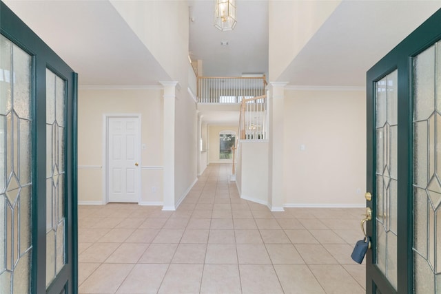 12236 S Shadow Cove Dr, Houston, TX 77082 - foyer entrance featuring light tile patterned flooring, a high ceiling, baseboards, ornamental molding, and a chandelier