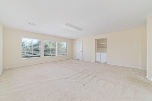12236 S Shadow Cove Dr, Houston, TX 77082 - unfurnished room with baseboards, built in shelves, and light colored carpet