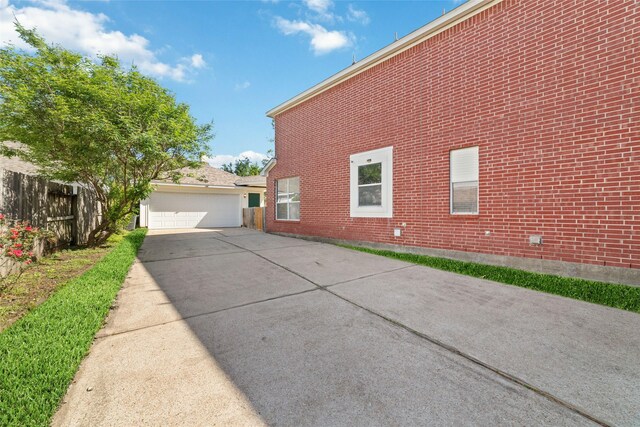 12236 S Shadow Cove Dr, Houston, TX 77082 - view of home's exterior featuring brick siding, fence, and a garage