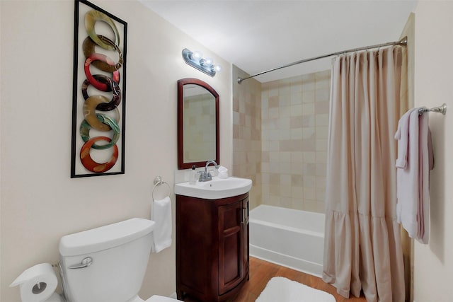 2810 Cottonwood Dr, Katy, TX 77493 - full bathroom featuring toilet, shower / bath combo with shower curtain, vanity, and wood finished floors