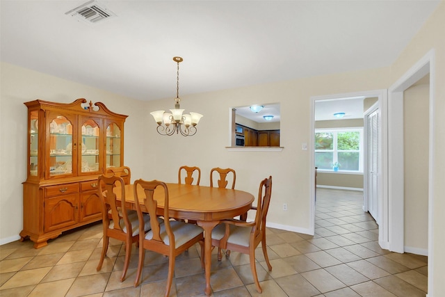2810 Cottonwood Dr, Katy, TX 77493 - dining room featuring a chandelier, light tile patterned floors, and baseboards