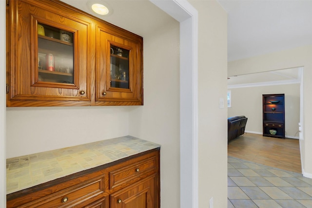 2810 Cottonwood Dr, Katy, TX 77493 - bar area featuring light tile patterned floors, ornamental molding, and baseboards