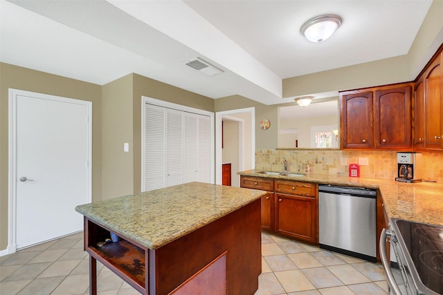 2810 Cottonwood Dr, Katy, TX 77493 - kitchen featuring stainless steel appliances, a sink, tasteful backsplash, light tile patterned floors, and light stone counters
