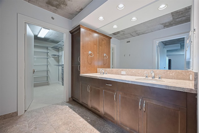 5005 Hidalgo St Unit 410, Houston, TX 77056 - bathroom featuring recessed lighting, double vanity, and a spacious closet