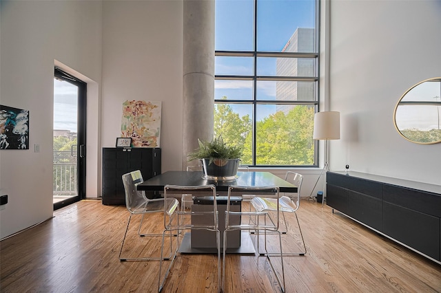 5005 Hidalgo St Unit 410, Houston, TX 77056 - dining room with a high ceiling, healthy amount of natural light, and wood finished floors