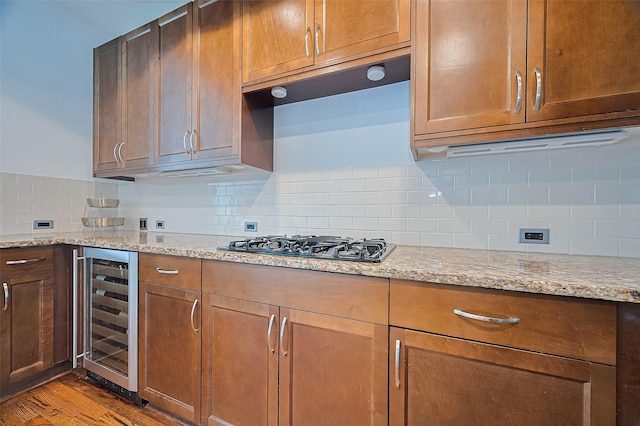 5005 Hidalgo St Unit 410, Houston, TX 77056 - kitchen with wine cooler, wood finished floors, light stone countertops, and decorative backsplash