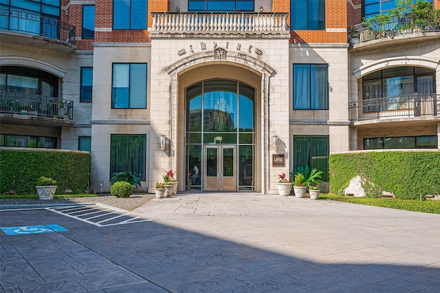 5005 Hidalgo St Unit 410, Houston, TX 77056 - entrance to property featuring french doors, brick siding, a balcony, and stone siding