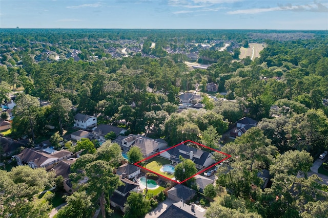 aerial perspective of suburban area featuring a forest and property boundaries highlighted