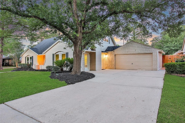 view of front of house with concrete driveway, an attached garage, and brick siding