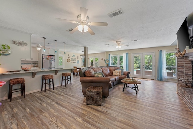 4701 County Road 747a, Brazoria, TX 77422 - living room featuring a textured ceiling, a ceiling fan, and wood finished floors