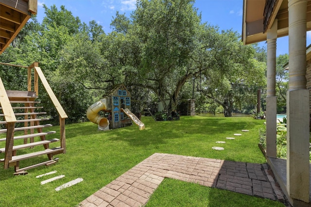 4701 County Road 747a, Brazoria, TX 77422 - view of green lawn with a playground, stairway, and view of scattered trees