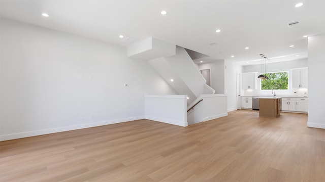 7229 Tierwester St, Houston, TX 77021 - unfurnished living room featuring light wood finished floors, recessed lighting, and baseboards