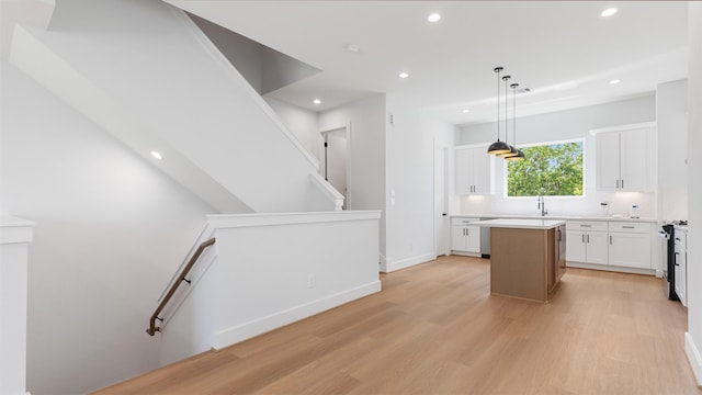 7229 Tierwester St, Houston, TX 77021 - kitchen featuring light wood-style floors, a center island, white cabinetry, recessed lighting, and decorative backsplash