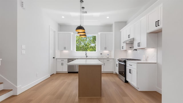 7229 Tierwester St, Houston, TX 77021 - kitchen featuring gas range oven, stainless steel dishwasher, light wood finished floors, tasteful backsplash, and recessed lighting