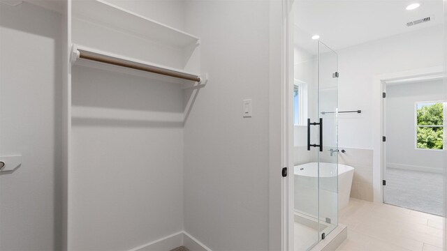 7229 Tierwester St, Houston, TX 77021 - bathroom featuring a soaking tub, tile patterned flooring, a stall shower, and recessed lighting