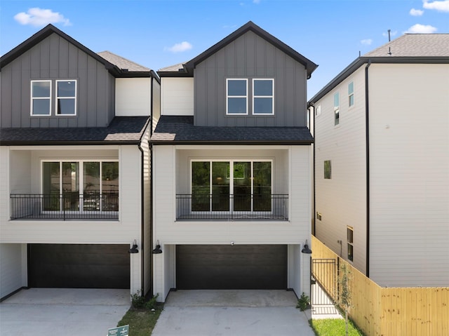 7229 Tierwester St, Houston, TX 77021 - view of front facade with board and batten siding, a garage, and a shingled roof