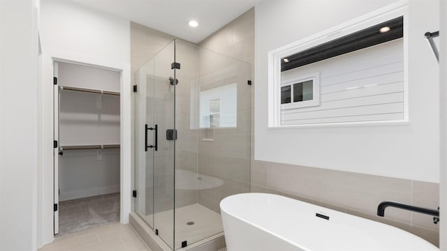 7229 Tierwester St, Houston, TX 77021 - full bath with a walk in closet, a shower stall, a freestanding bath, recessed lighting, and tile patterned flooring