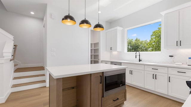 7229 Tierwester St, Houston, TX 77021 - kitchen featuring built in microwave, light wood-style floors, decorative backsplash, light countertops, and recessed lighting
