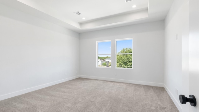 7229 Tierwester St, Houston, TX 77021 - empty room featuring light carpet, baseboards, a raised ceiling, and recessed lighting