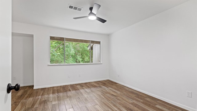 2139 E Settlers Way, The Woodlands, TX 77380 - unfurnished room with wood finished floors, a ceiling fan, and baseboards