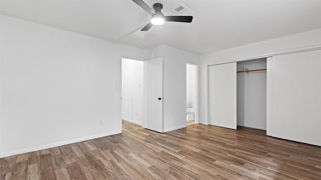 2139 E Settlers Way, The Woodlands, TX 77380 - unfurnished bedroom with wood finished floors, ensuite bath, baseboards, a closet, and a ceiling fan
