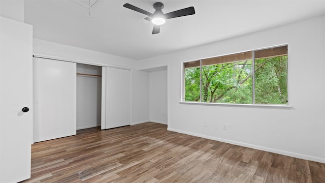 2139 E Settlers Way, The Woodlands, TX 77380 - unfurnished bedroom with wood finished floors, a closet, baseboards, and attic access