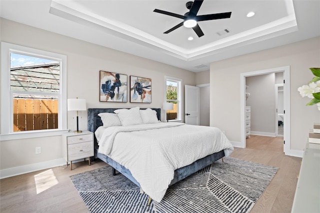 1118 W Cottage St, Houston, TX 77009 - bedroom with a raised ceiling, light wood-type flooring, recessed lighting, and baseboards