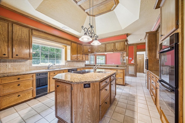15706 Pinewood Cove Dr, Houston, TX 77062 - kitchen with a sink, a textured ceiling, an island with sink, brown cabinets, and decorative backsplash