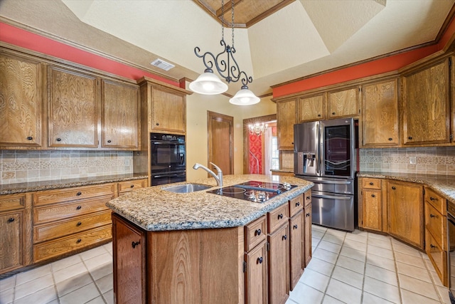15706 Pinewood Cove Dr, Houston, TX 77062 - kitchen featuring black appliances, light tile patterned flooring, a sink, brown cabinetry, and a center island with sink