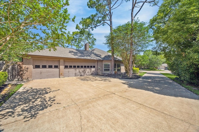 15706 Pinewood Cove Dr, Houston, TX 77062 - view of front of property with brick siding, driveway, a garage, and a chimney