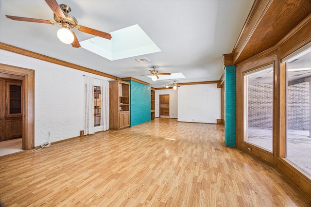 15706 Pinewood Cove Dr, Houston, TX 77062 - unfurnished living room featuring a skylight, ornamental molding, ceiling fan, light wood-type flooring, and brick wall