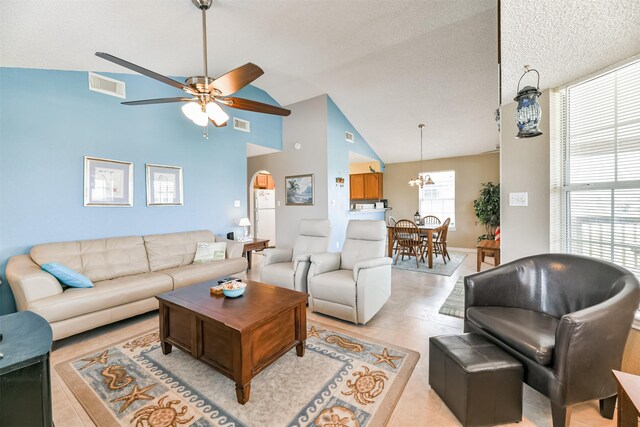 4030 Fort Bend Dr, Galveston, TX 77554 - living room featuring arched walkways, a ceiling fan, light tile patterned floors, and high vaulted ceiling