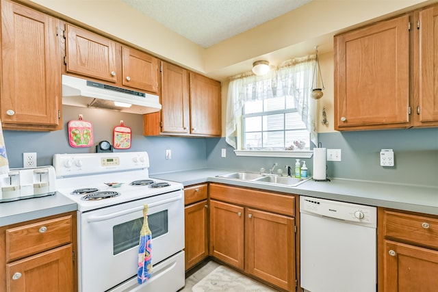 4030 Fort Bend Dr, Galveston, TX 77554 - kitchen with white appliances, under cabinet range hood, a sink, and light countertops