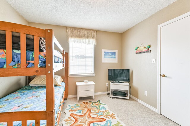 4030 Fort Bend Dr, Galveston, TX 77554 - carpeted bedroom featuring a textured ceiling and baseboards