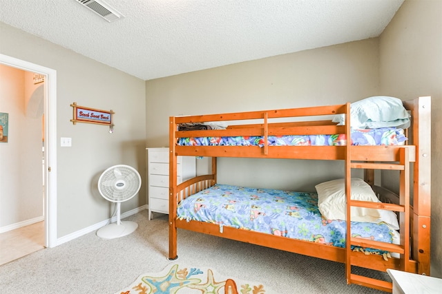 4030 Fort Bend Dr, Galveston, TX 77554 - bedroom featuring carpet, a textured ceiling, and baseboards