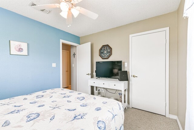 4030 Fort Bend Dr, Galveston, TX 77554 - bedroom featuring carpet floors, a ceiling fan, baseboards, and a textured ceiling