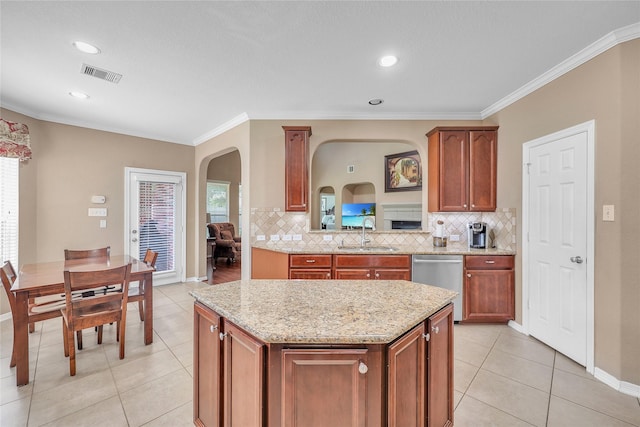 24628 Hosford Meadows Dr, Porter, TX 77365 - kitchen with dishwasher, arched walkways, a kitchen island, decorative backsplash, and crown molding