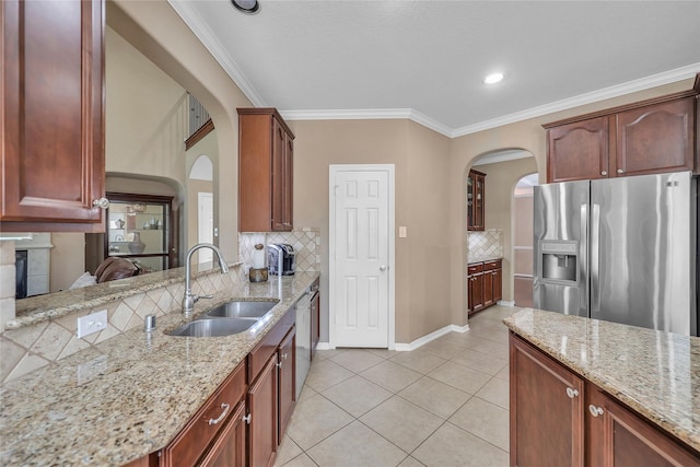 24628 Hosford Meadows Dr, Porter, TX 77365 - kitchen with stainless steel fridge, arched walkways, a sink, backsplash, and light tile patterned floors