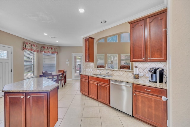 24628 Hosford Meadows Dr, Porter, TX 77365 - kitchen with dishwasher, a sink, tasteful backsplash, light stone counters, and light tile patterned floors