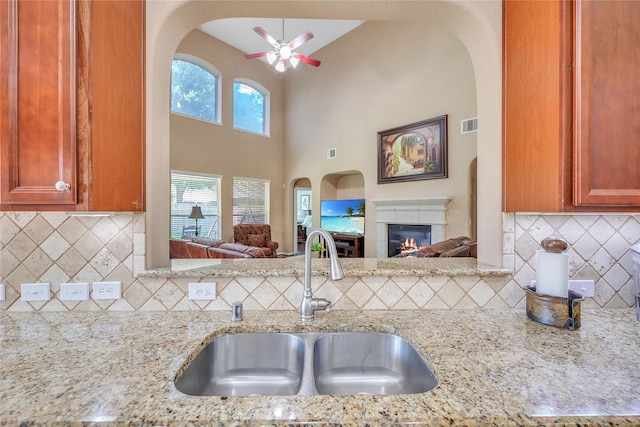 24628 Hosford Meadows Dr, Porter, TX 77365 - kitchen with a sink, tasteful backsplash, ceiling fan, and light stone countertops