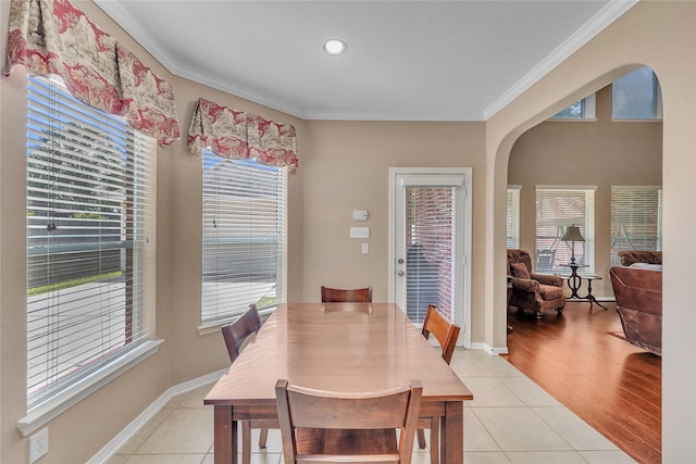 24628 Hosford Meadows Dr, Porter, TX 77365 - dining space featuring arched walkways, crown molding, light tile patterned floors, and baseboards