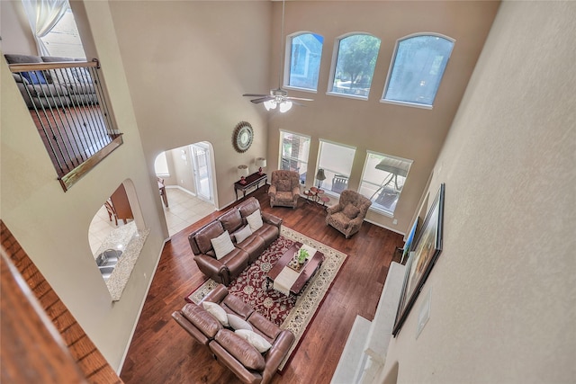 24628 Hosford Meadows Dr, Porter, TX 77365 - living area with a towering ceiling, a ceiling fan, arched walkways, and wood finished floors