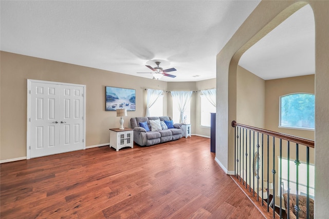 24628 Hosford Meadows Dr, Porter, TX 77365 - living room with wood finished floors, ceiling fan, arched walkways, and baseboards