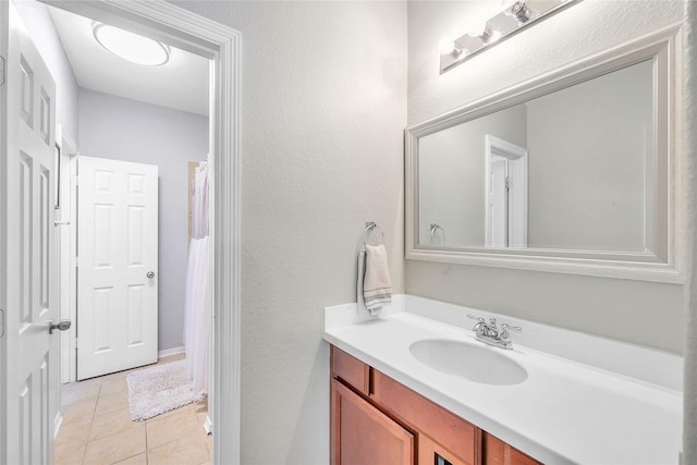 24628 Hosford Meadows Dr, Porter, TX 77365 - full bathroom featuring vanity, tile patterned floors, and a textured wall