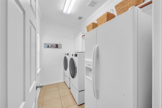 24628 Hosford Meadows Dr, Porter, TX 77365 - clothes washing area with washing machine and dryer, cabinet space, ornamental molding, light tile patterned floors, and baseboards