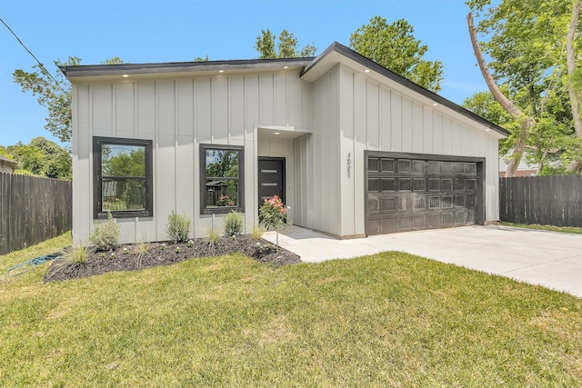 4021 King St, Houston, TX 77026 - view of front of property with an attached garage, driveway, and board and batten siding