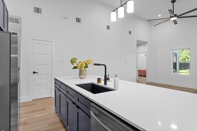 4021 King St, Houston, TX 77026 - kitchen featuring a high ceiling, a sink, appliances with stainless steel finishes, light countertops, and a ceiling fan
